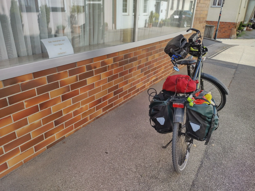 Ich habe mein Fahrrad vor einem Laden abgestellt, in dessen Schaufenster steht 'Fahrräder abstellen verboten'.